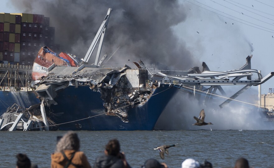 Explosive charges are detonated to bring down sections of the collapsed Francis Scott Key Bridge resting on the container ship Dali on Monday in Baltimore.
