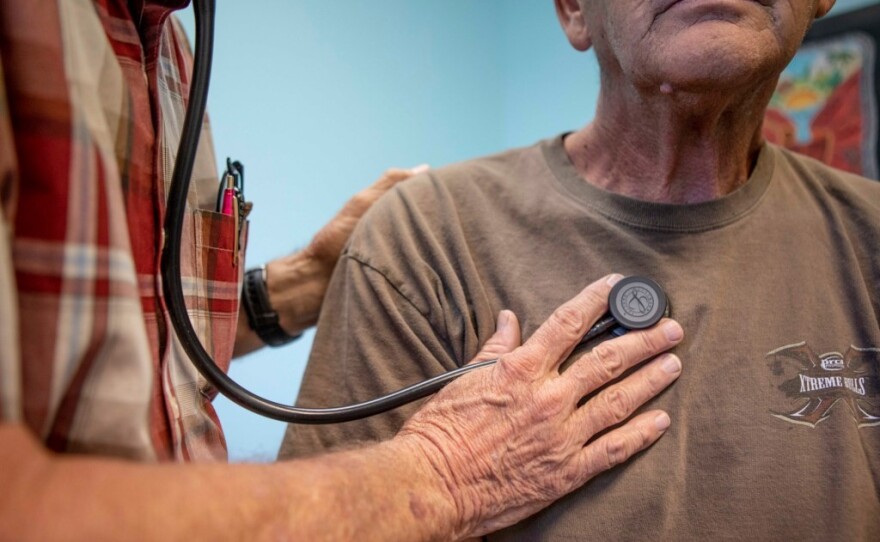 A doctor listens to a man's heartbeat at a clinic in Bieber, California on July 23, 2019.