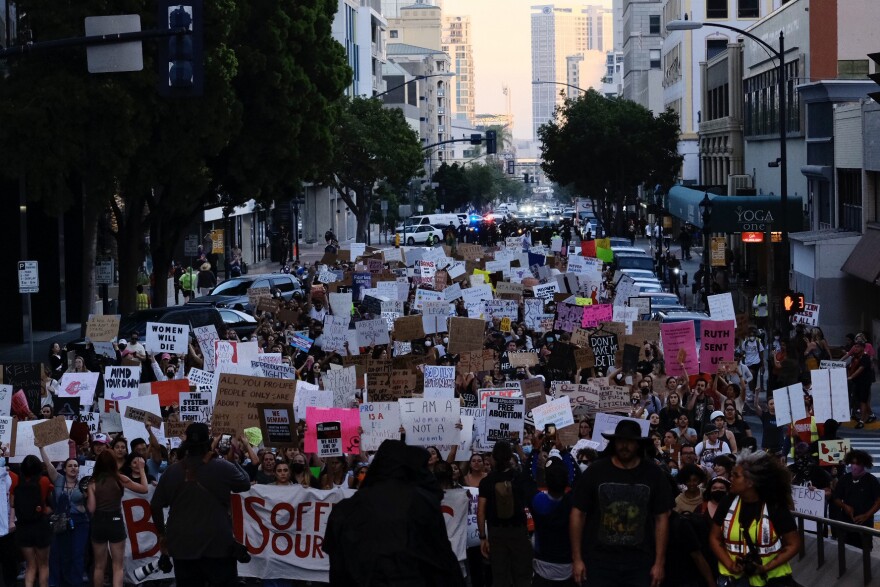 The protesters turned north on Sixth Avenue, still chanting and holding their signs high on Friday, June 24, 2022