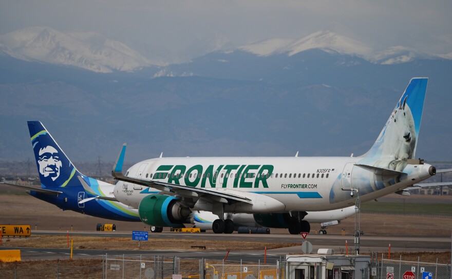 A Frontier Airlines jetliner waits for clearance to take off as high winds strafe Denver International Airport Thursday, March 12, 2026, in Denver.