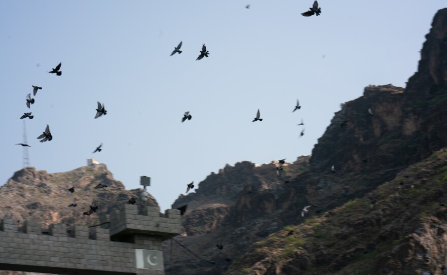 Birds fly above Torkham.