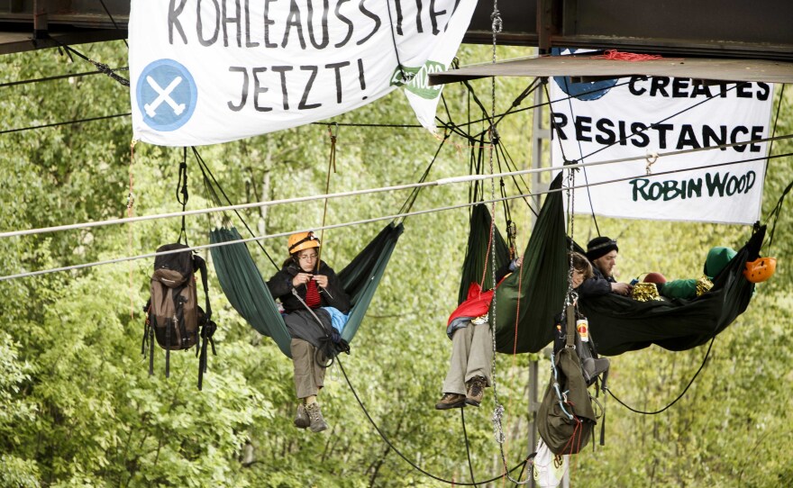 Activists from the environmental organization Robin Wood tied hammocks to a railway bridge on Sunday during a blockade of the coal mine company Vattenfall's Schwarze Pumpe power station near Spremberg, Germany.