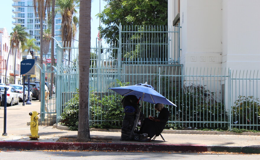 A person experiencing homelessness in downtown San Diego.