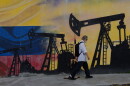 A pedestrian walks past a mural featuring oil wells in Caracas, Venezuela, Saturday, Aug 29, 2026, a day after President Donald Trump announced a deal giving the United States a stake in Venezuela's oil reserves.