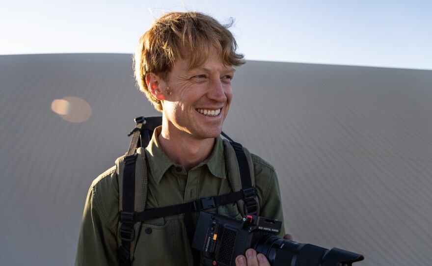 Filmmaker Ben Masters crosses the sand dunes in South Texas to reach the ocelot habitat, where he has placed camera traps.