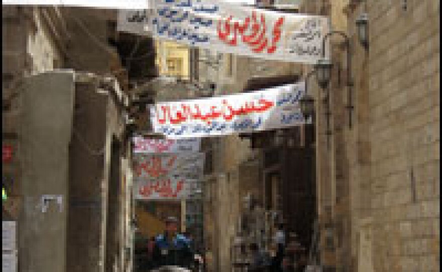 Banners promote candidates in Tuesday's Egyptian elections.