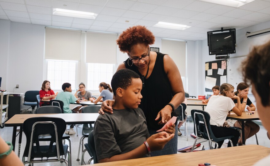 Bryan Bailey in math class with his teacher, Kirsten Turner.