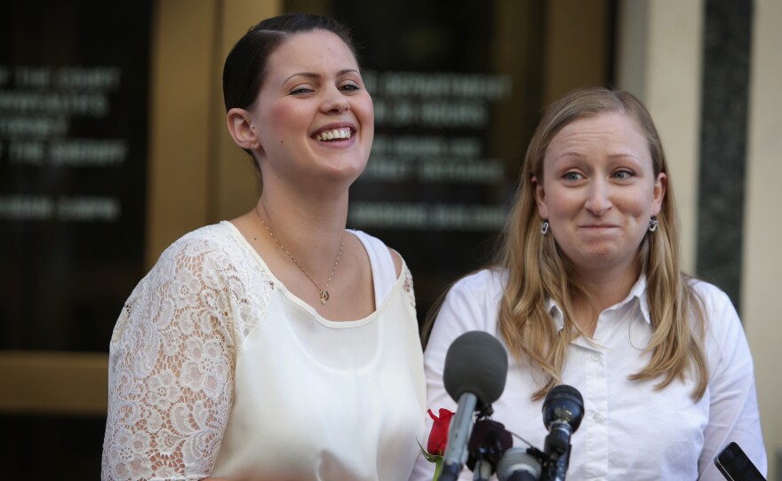 Erika Turner, right, and Jennifer Melsop  of Centreville, Virginia, rejoice as they becomes the first same-sex couple to marry in Arlington County.