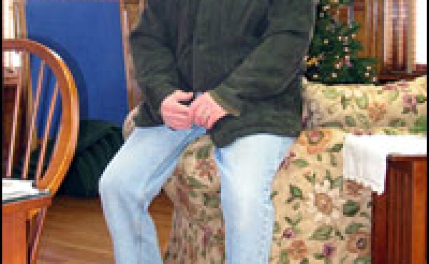 Keith Beadle, a former border inspector, straddles the U.S.-Canadian border inside the Haskell Free Library in Derby Line, Vt. Beadle's right foot rests on the U.S. side.