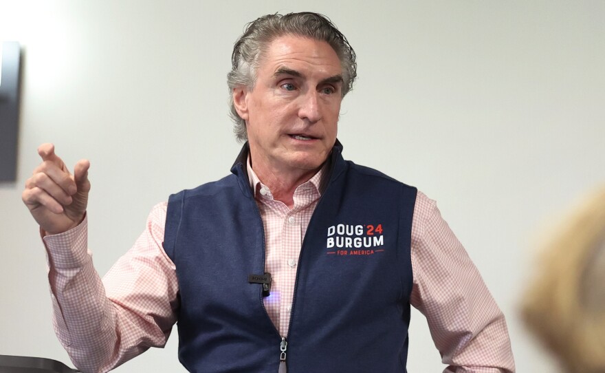 Republican presidential contender Doug Burgum, who's governor of North Dakota, is offering to send people $20 gift cards if they donate as little as $1 to his campaign. He's seen here last month speaking in Ankeny, Iowa.