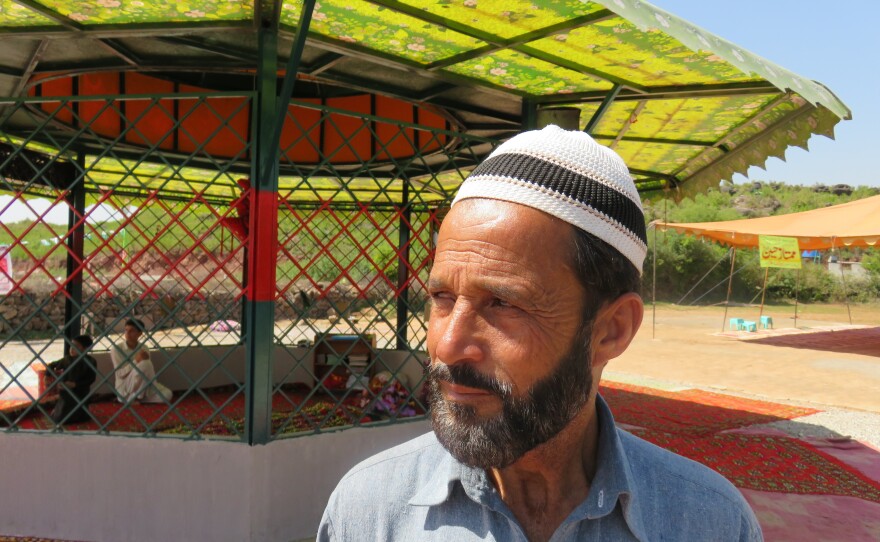 Raja Nafees Ahmed at the grave of his son-in-law, Mumtaz Qadri, near the Pakistan capital of Islamabad. Qadri was a policeman in 2011 when he shot and killed a politician who questioned the country's blasphemy laws. Qadri was hanged last month and his grave has become a shrine for supporters who insist that blasphemy laws not be eased.