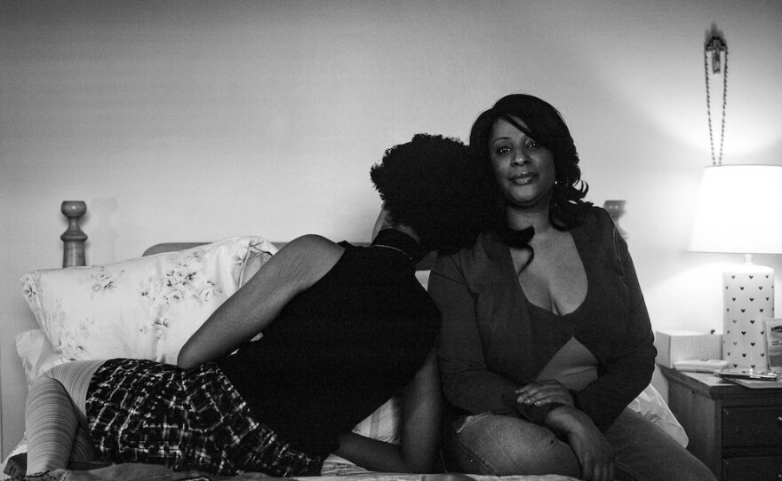 Mikaela Gumbel, 20, sits with her mother in Mikaela's childhood bedroom in Westchester County, N.Y.