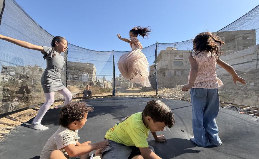 Palestinian children leap into the air while playing on a trampoline in northern Gaza's militarized orange zone of Beit Lahia, on May 31.