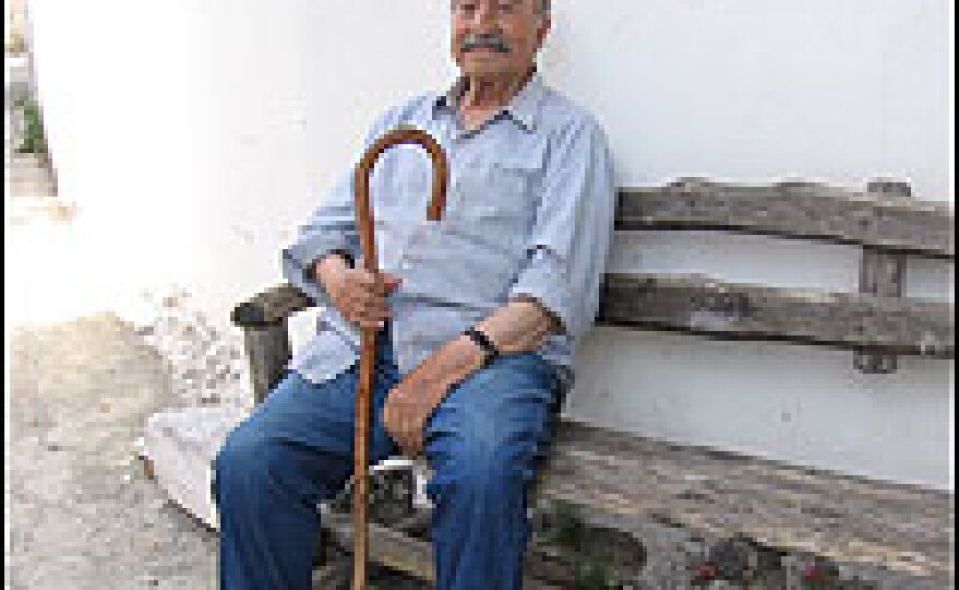 Michalis Fiorakis, age 101, comes out of his home in Avdou during the cooler evenings to greet people from this bench. After napping, he goes to the taverna to eat and drink with friends. He's known for singing as he walks up and down the streets.