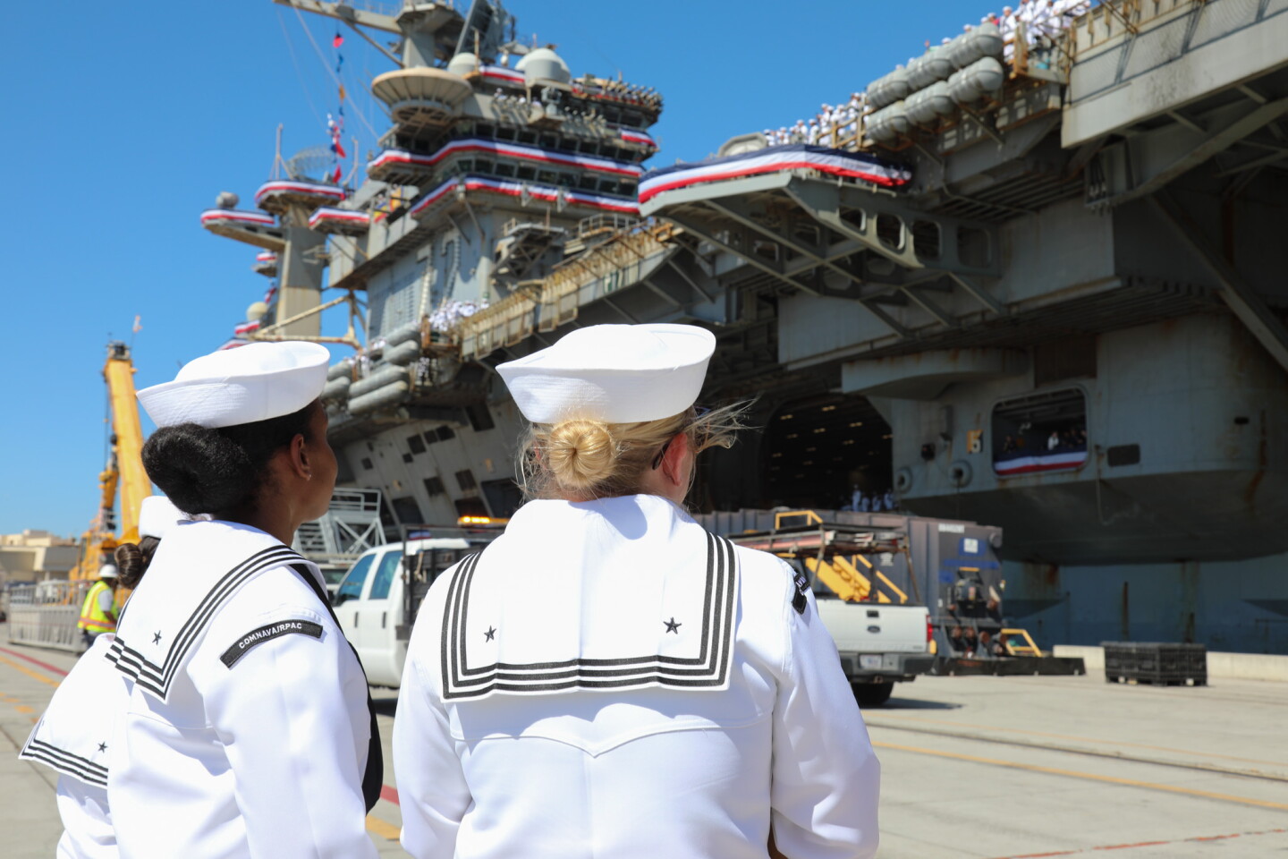 Two Sailors welcome USS Lincoln's landing on Oct. 8, 2026.