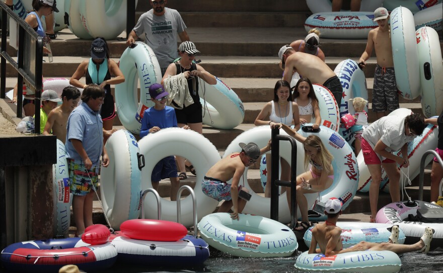 Tubers prepare to float the Comal River in New Braunfels, Texas, on Thursday. Texas Gov. Greg Abbott said Wednesday that the state is facing a "massive outbreak" of the coronavirus and that some new local restrictions may be needed to preserve hospital space for new patients.