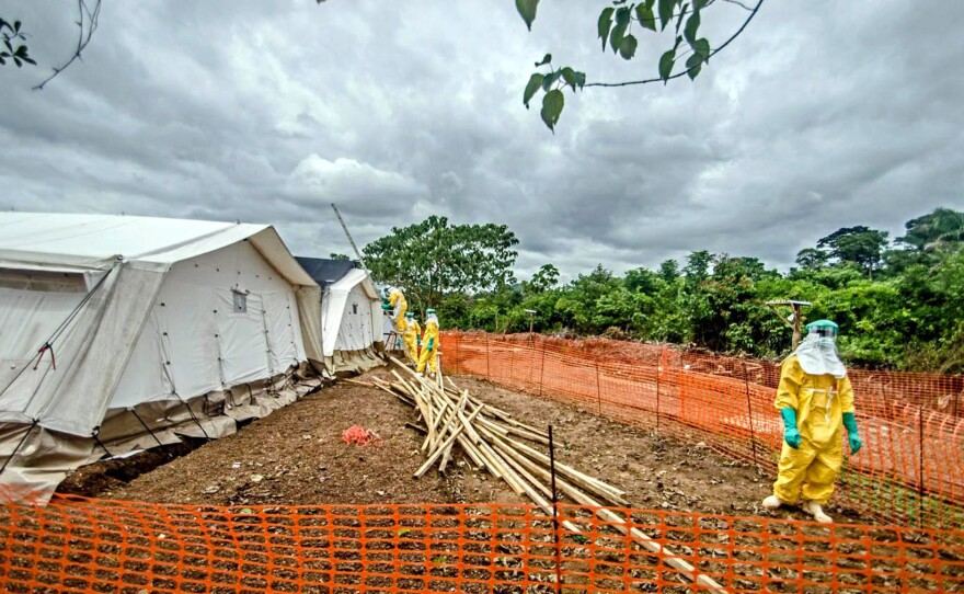 Construction workers repair the roof inside the isolation area at the Doctors Without Borders treatment center in Kailahun.