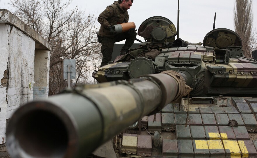 Ukrainian servicemen get ready to repel an attack in Ukraine's Lugansk region on Feb. 24.
