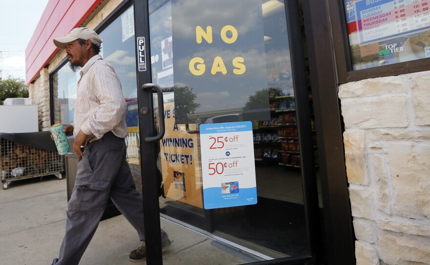 A customer walks out of an Exxon station in Bedford, Texas, Thursday. Refinery shutdowns have sent prices up all over the country.