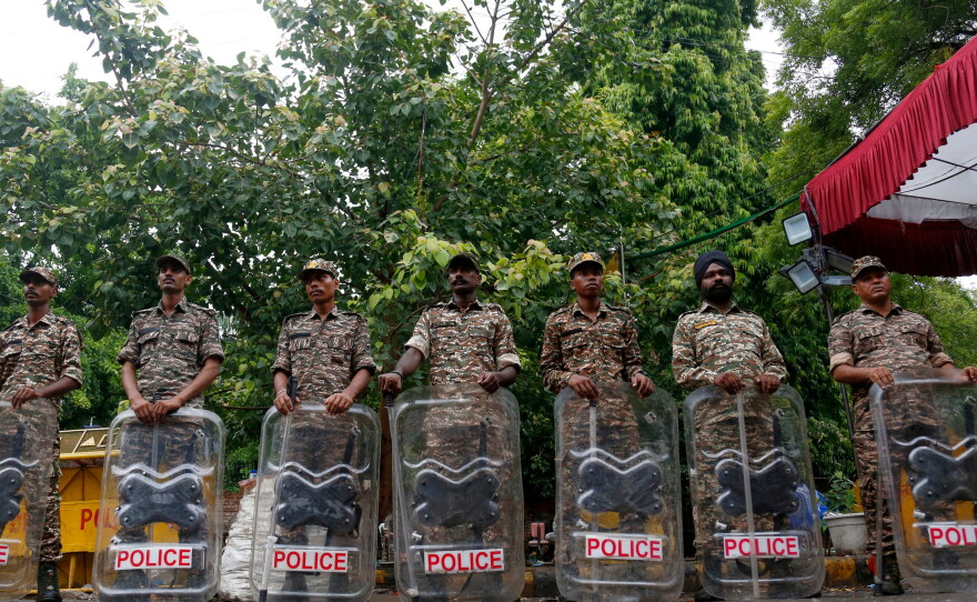 Security officers stand guard at the camping site of the Cockroach Janta Party at Jantar Mantar in New Delhi, Tuesday, July 21, 2026.