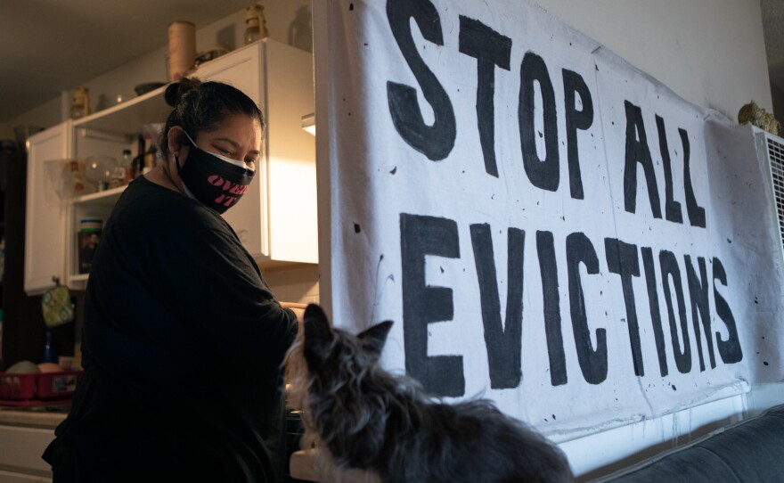 Patty Mendoza looks toward her dog, Chula, while cooking breakfast for her children at her Imperial Beach apartment, March 23, 2021.