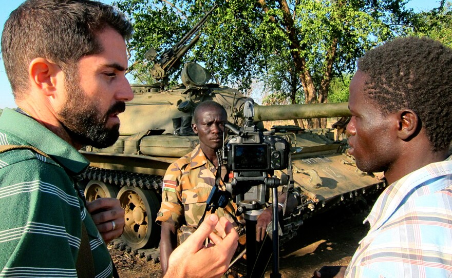 American Ryan Boyette, left, works with Yassin Hassen, right, in an interview with a rebel in Sudan's Nuba Mountains. Boyette started the Nuba Reports website in 2011 and recruited Hassen to join as a citizen journalist.
