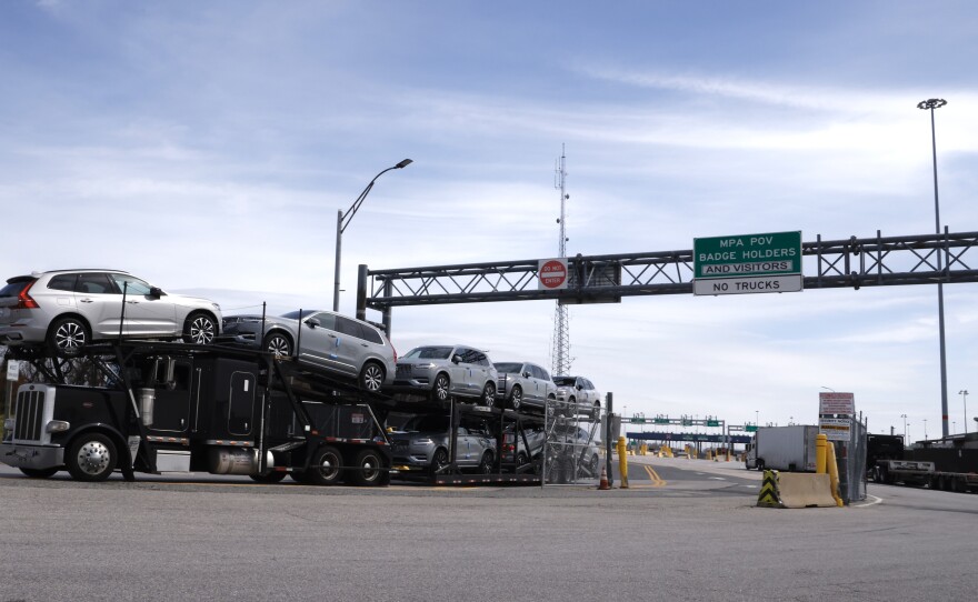 Cars exit from the Baltimore Port after the cargo ship Dali ran into and collapsed the Francis Scott Key Bridge in Baltimore, Md., on Tuesday. Two people were pulled alive from the water, two bodies were recovered and four people were presumed dead. The men were working on the bridge at the time of the collision at 1:30 a.m.