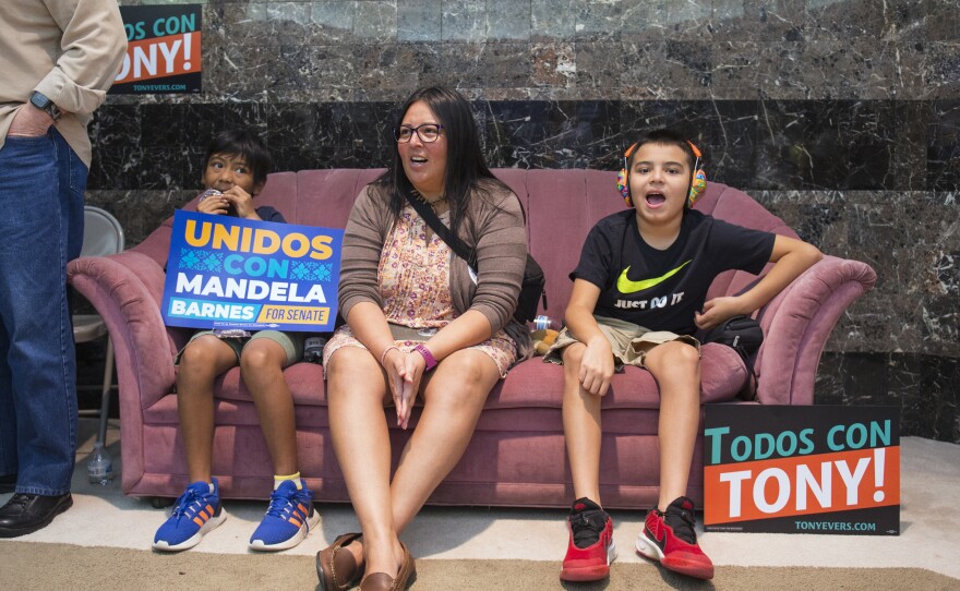 Daysi Jiménez (center) and her sons (from left) Ben and Christopher cheer for U.S. Senate candidate Mandela Barnes as he gives a speech at a Latinos for Mandela event at the Milwaukee Democratic Party office in Milwaukee on Saturday.