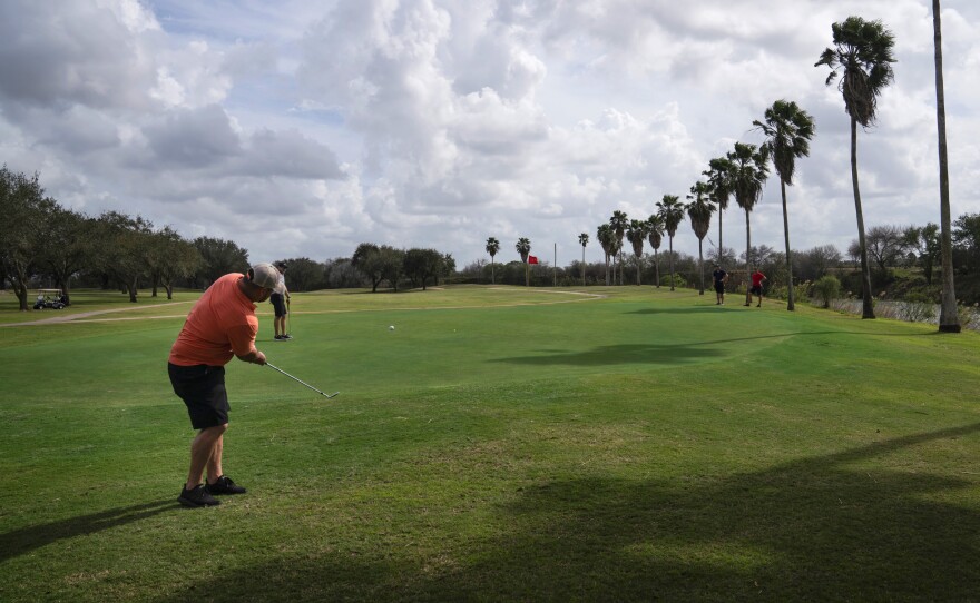 Memo Ibarra makes a chip shot at River Bend Resort & Golf Club in Brownsville, Texas. The 18-hole golf course would have 15 of them on the south side of Trump's proposed border wall.