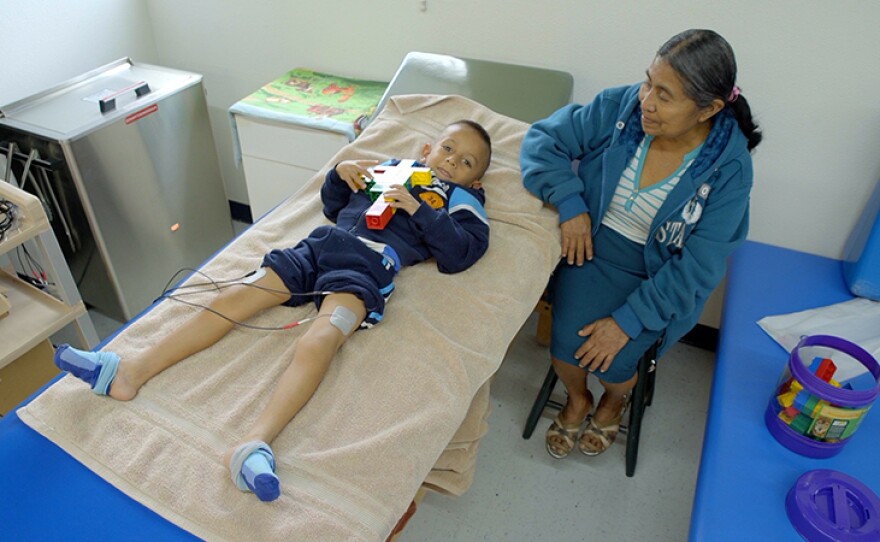 A child smiles at the camera while receiving treatment at a charitable children's hosptial in Tijuana, Baja Calif.