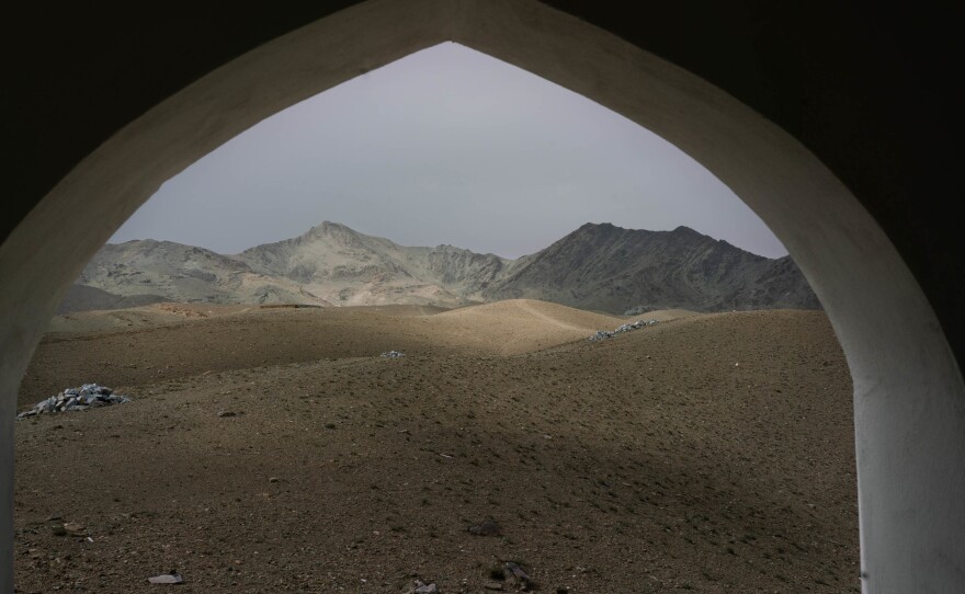 Distant mountains can be seen from an archway of a mosque in the Tangi Valley.