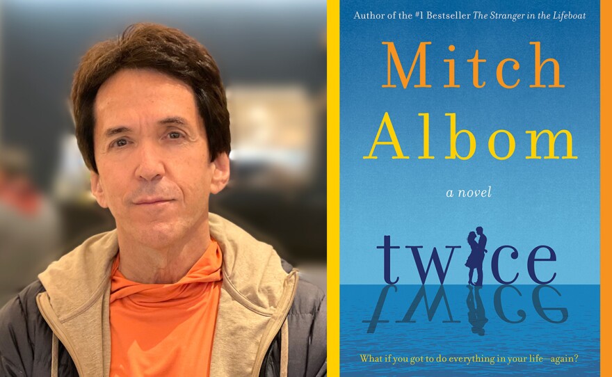 The image is an undated photograph of author Mitch Albom and shows the book cover for his novel "Twice."