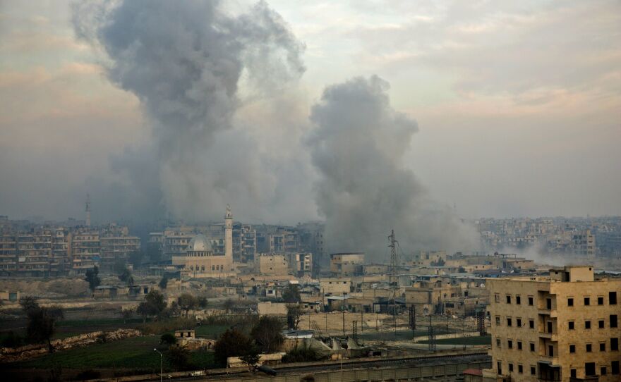 Smoke billows from the former rebel-held district of Bustan al-Qasr in Aleppo on Monday during an operation by Syrian government forces to retake the embattled city.