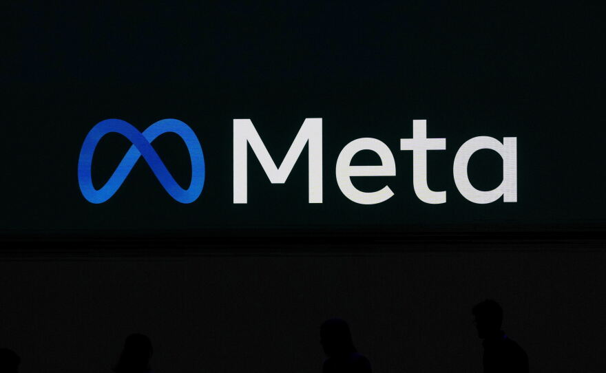 FILE - A Meta logo is shown on a video screen at LlamaCon 2025, an AI developer conference, in Menlo Park, Calif., April 29, 2025.