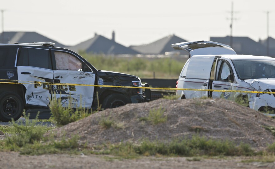 An Odessa police SUV and a U.S. Postal Service minivan that were both involved in Saturday's shooting are pictured outside the Cinergy entertainment center on Sept. 1 in Odessa, Texas.