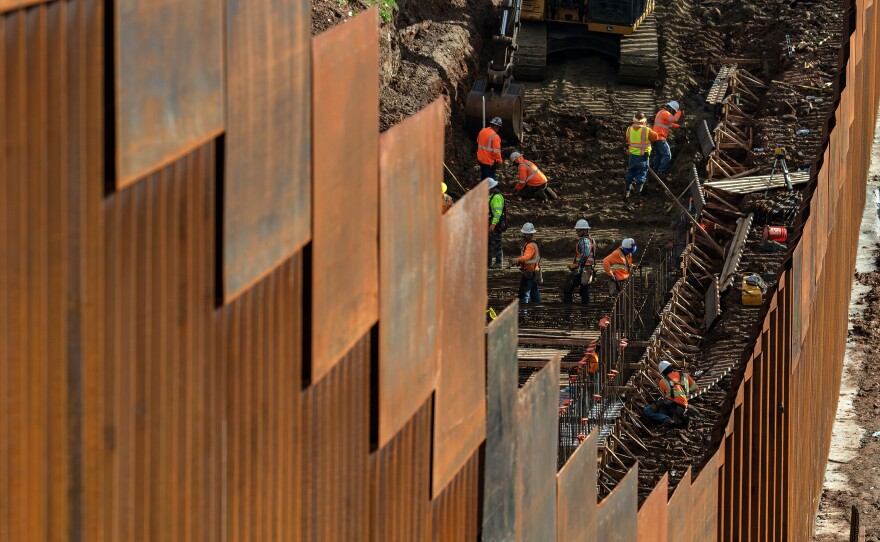 Workers reinforce a section of the U.S.-Mexico border fence, as seen from eastern Tijuana, Mexico, on January 18, 2019.