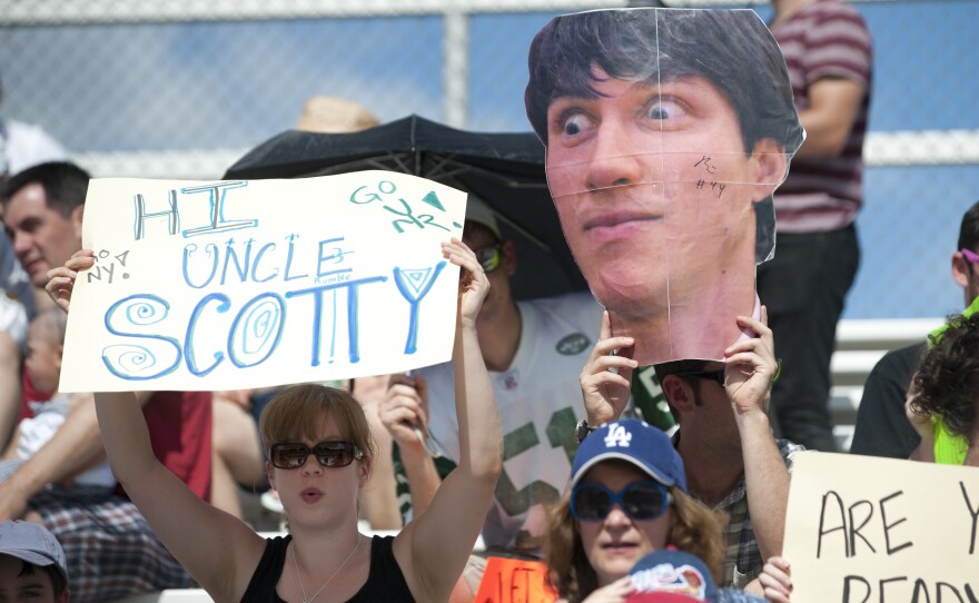 Fans hold up signs with funny slogans and players' names in support of their favorite Ultimate Frisbee players. The stands were filled primarily with DC supporters, but fans for New York were present as well.