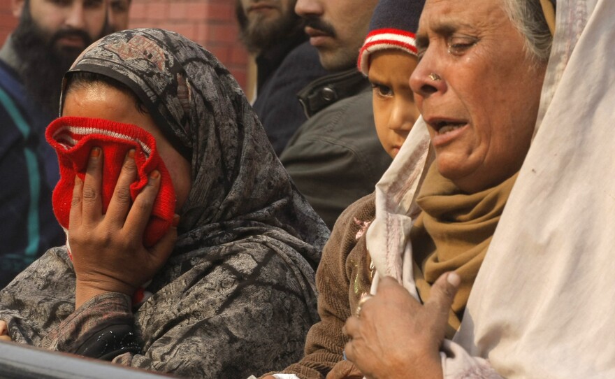 Relatives of injured students react as they arrive at a hospital dealing with the victims of an attack by Taliban gunmen on a school in Peshawar, Pakistan on Tuesday.