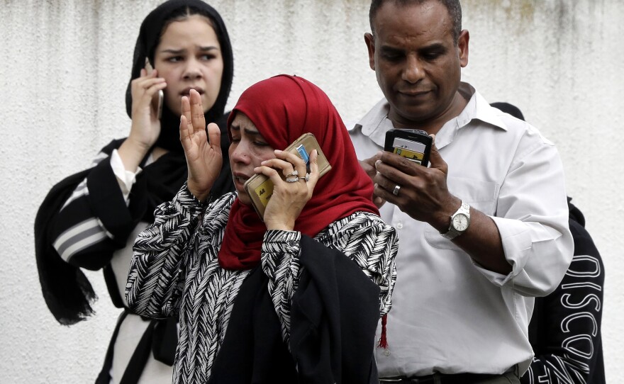People wait outside the Al Noor mosque following a mass shooting March 15, 2019, in central Christchurch, New Zealand.