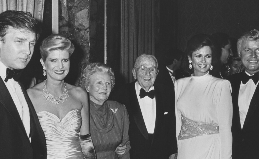 Businessman Donald Trump and wife Ivana with author Norman Vincent Peale and his wife, Ruth Peale, Phyllis George and Gov. John Brown at Peale's birthday party at the Waldorf Hotel in New York City in 1988.