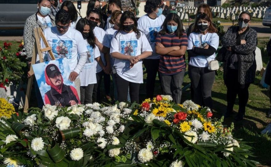 Relatives and friends of photojournalist Margarito Martinez mourn graveside in Tijuana, Baja California, Mexico.