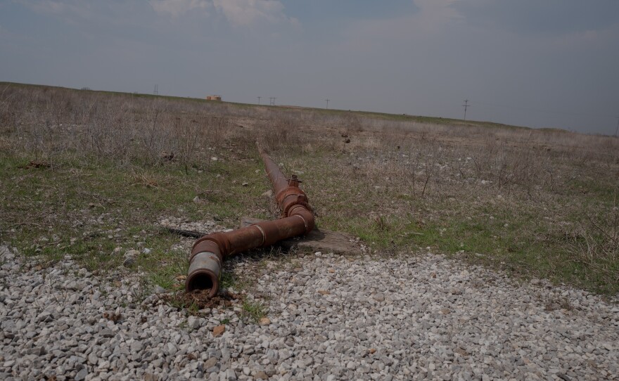 A pipe, left over from a now-defunct piece of oil equipment, stretches across the land in the Tallgrass Prairie Preserve in Oklahoma on March 20, 2024.