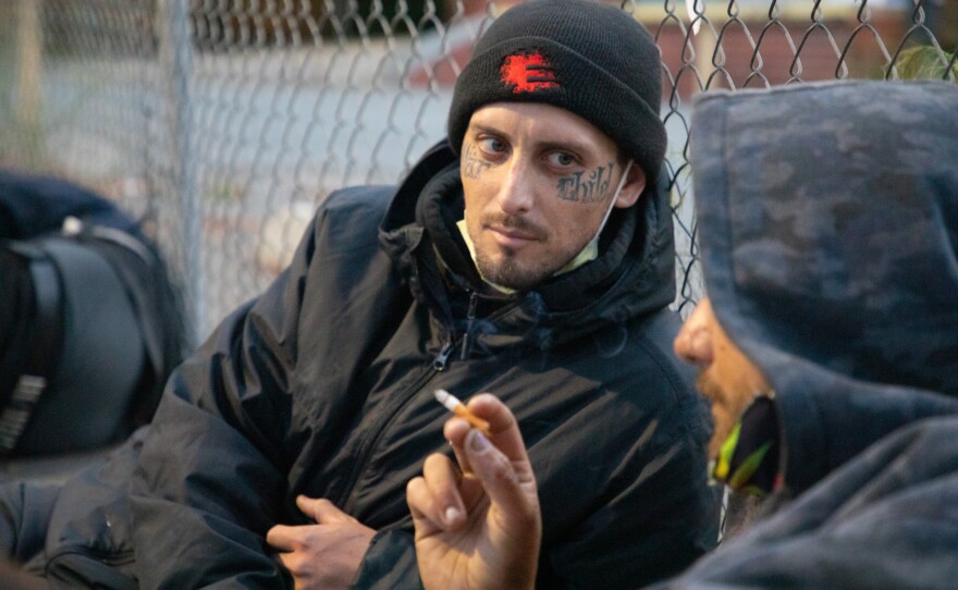 Dustin Boyle, left, talks with his friend Zachary Markovich before dawn on 16th Street in San Diego, May 20, 2020.