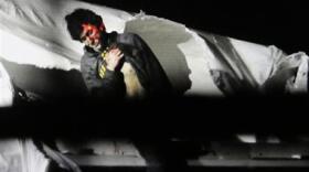 In this Friday, April 19, 2013 Massachusetts State Police file photo, 19-year-old Boston Marathon bombing suspect Dzhokhar Tsarnaev, bloody and disheveled with the red dot of a sniper's rifle laser sight on his head, emerges from a boat at the time of his capture by law enforcement authorities in Watertown, Mass. 