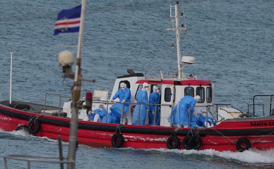 Health workers in protective gear arrive to evacuate patients from the MV Hondius cruise ship at a port in Praia, Cape Verde, Wednesday, May 6, 2026.
