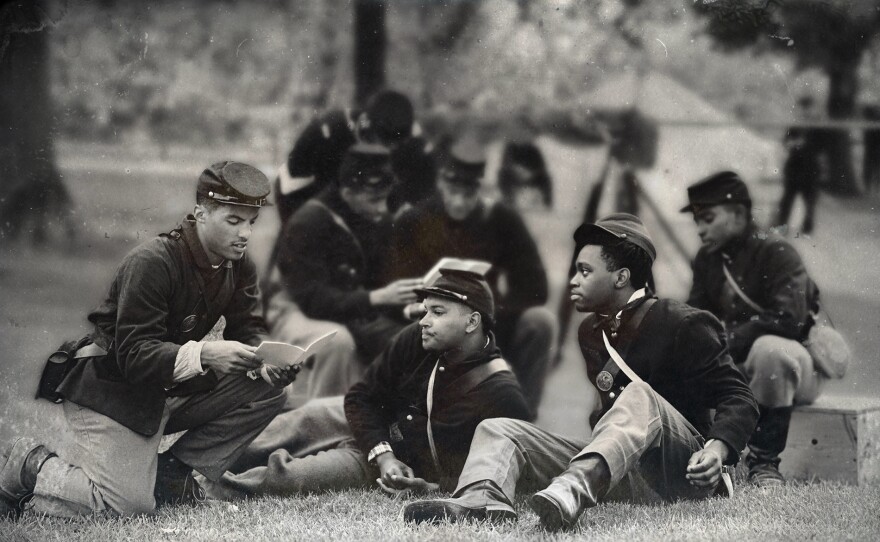 Actors portray soldiers of the 5th U.S. Colored Cavalry gathering in their downtime at Camp Nelson to learn how to read and write.