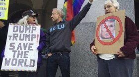 Protesters stand on the steps of the state Capitol in Sacramento, Dec. 19, 2016.