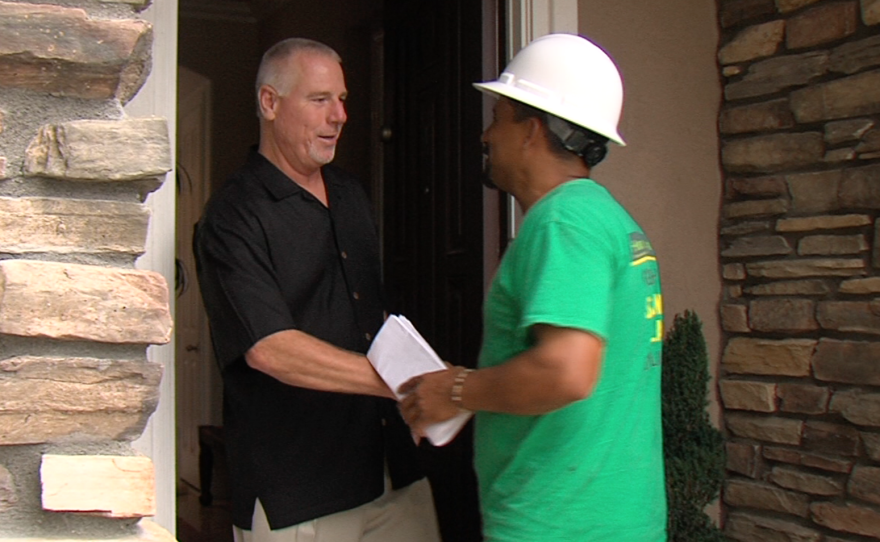 Carmel Valley homeowner Ron Johnson (left) greets solar panel installation manager Phil Salas, Oct. 12, 2015.