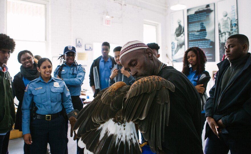 Rodney Stotts talks with students as part of a D.C. police program to expose youth to career and community service opportunities.