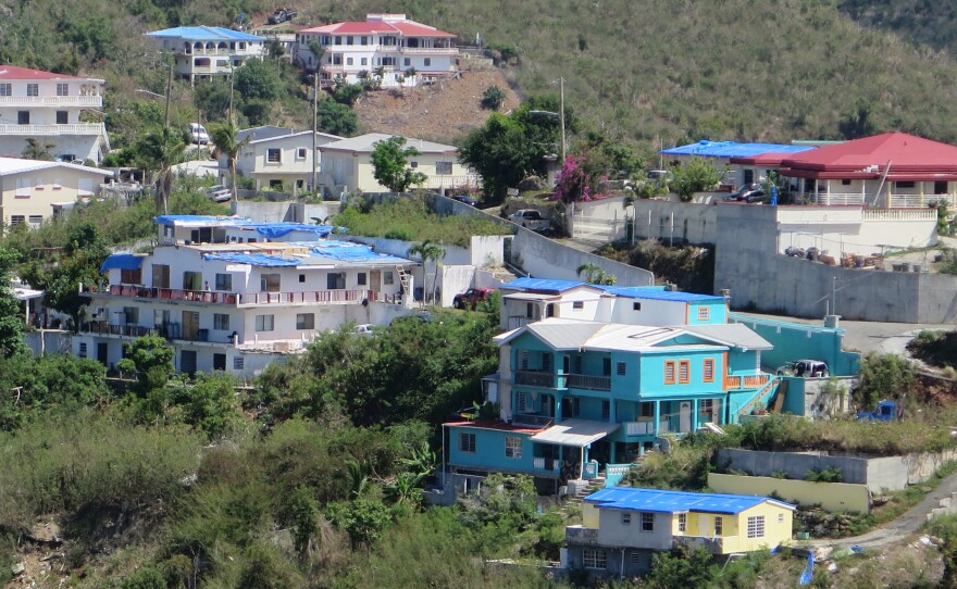 People are living in homes where roofs, windows, even walls are missing, using blue tarps to keep the elements at bay.